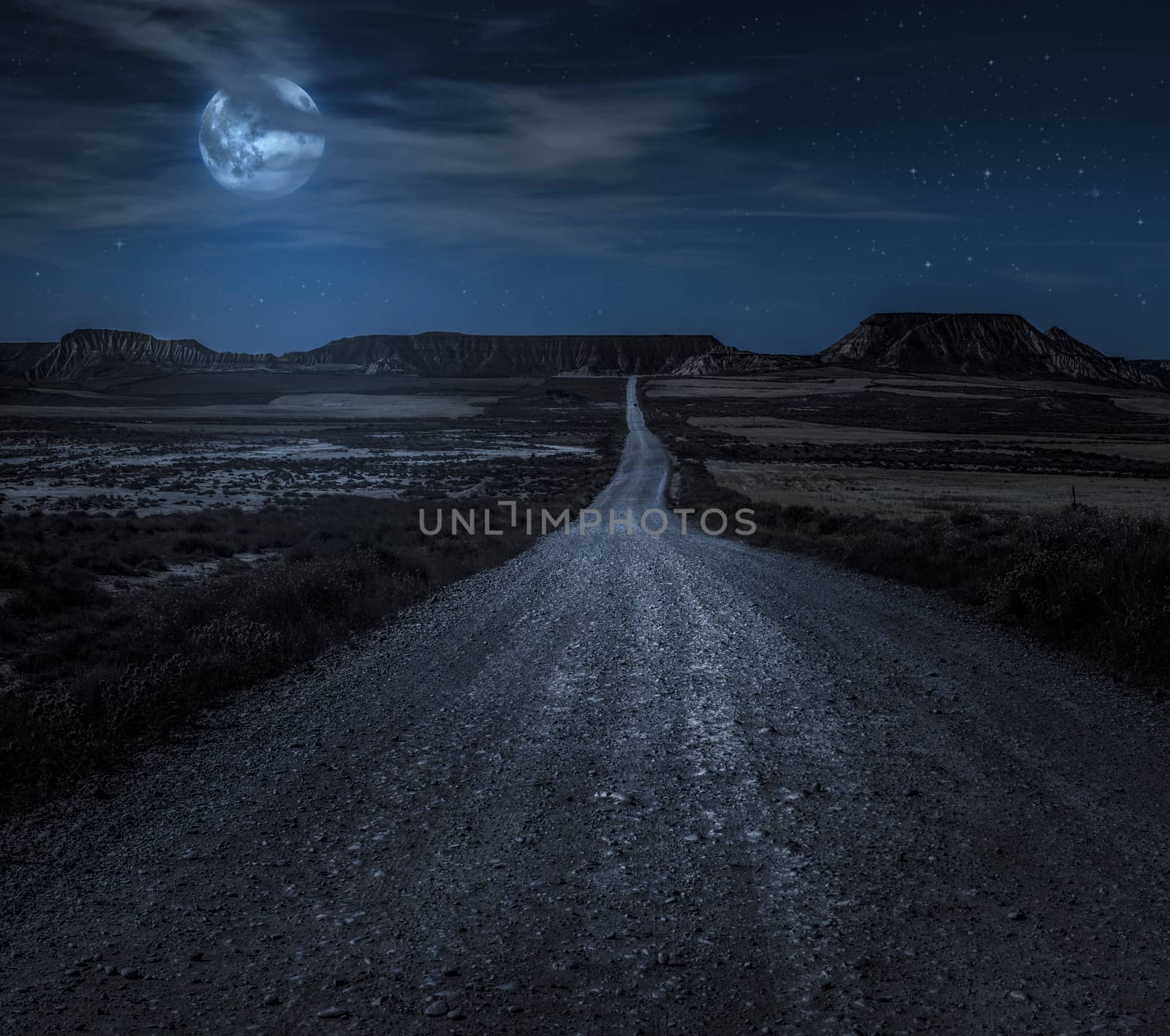 Moon, stars and clouds in the night. Wild west road illuminated  by deyan_georgiev