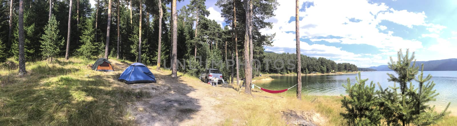 Panoramic image of forest and mountain lake. Tents and car in th by deyan_georgiev