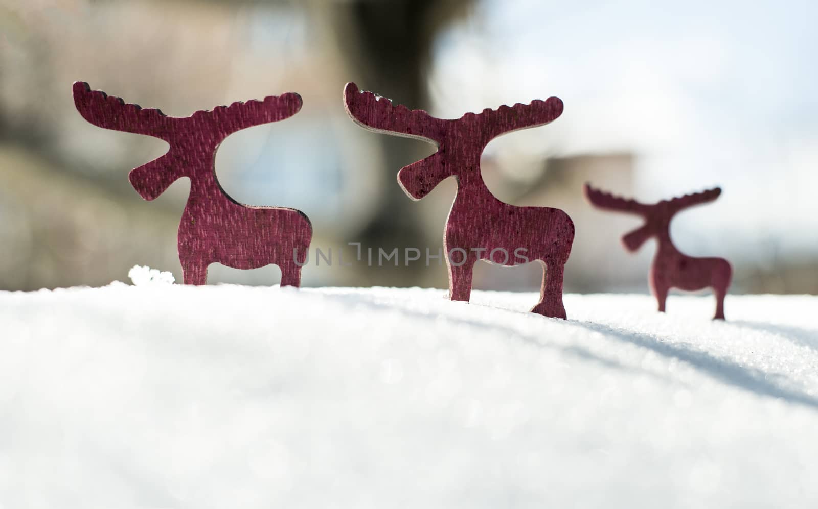 Wooden Christmas deer shape on snow.