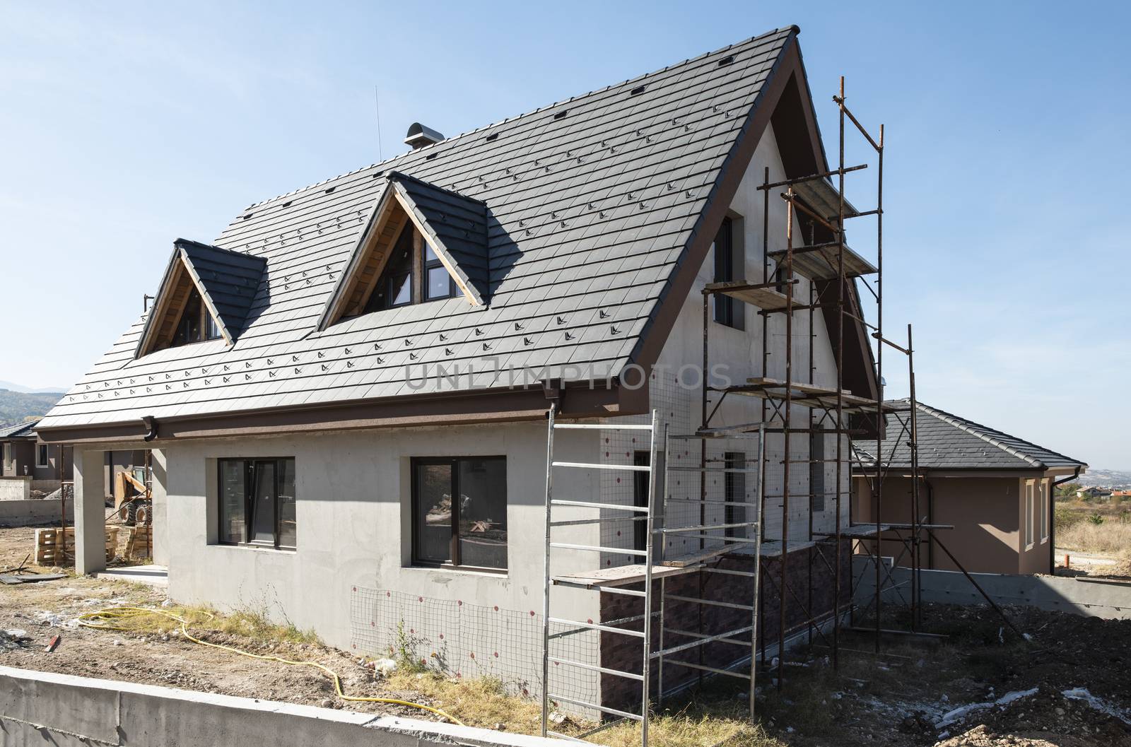 New build houses. Black roof, mountain