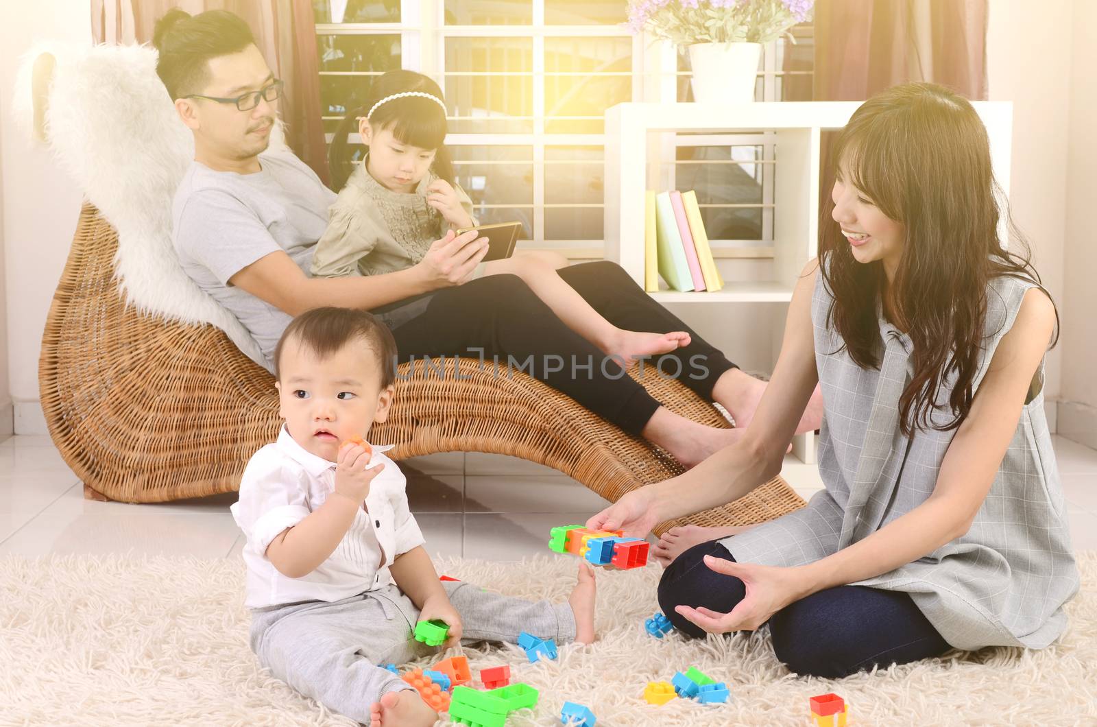 Asian family playing toys at living room