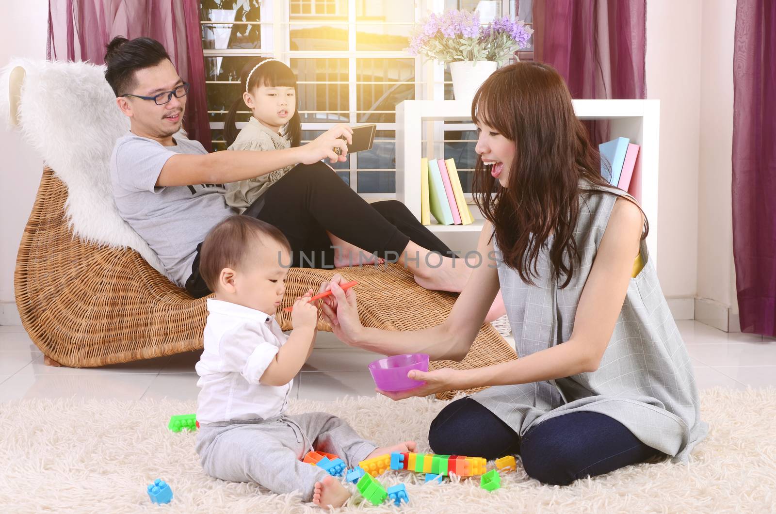 Asian family playing toys at living room