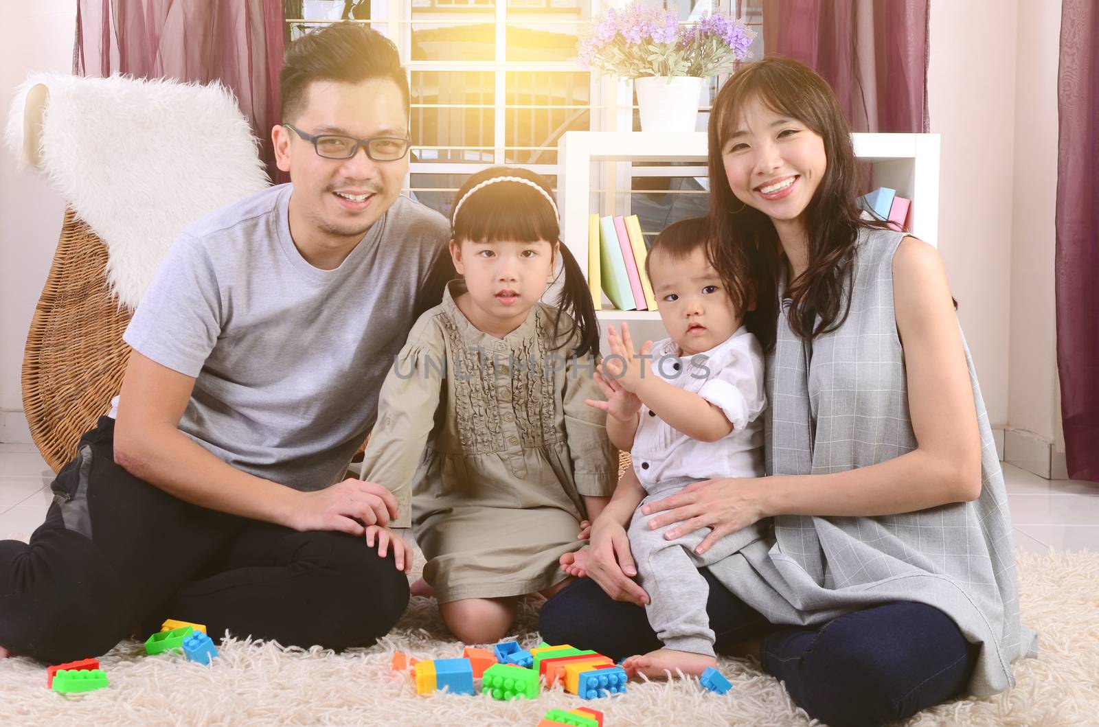 Asian family playing toys at living room