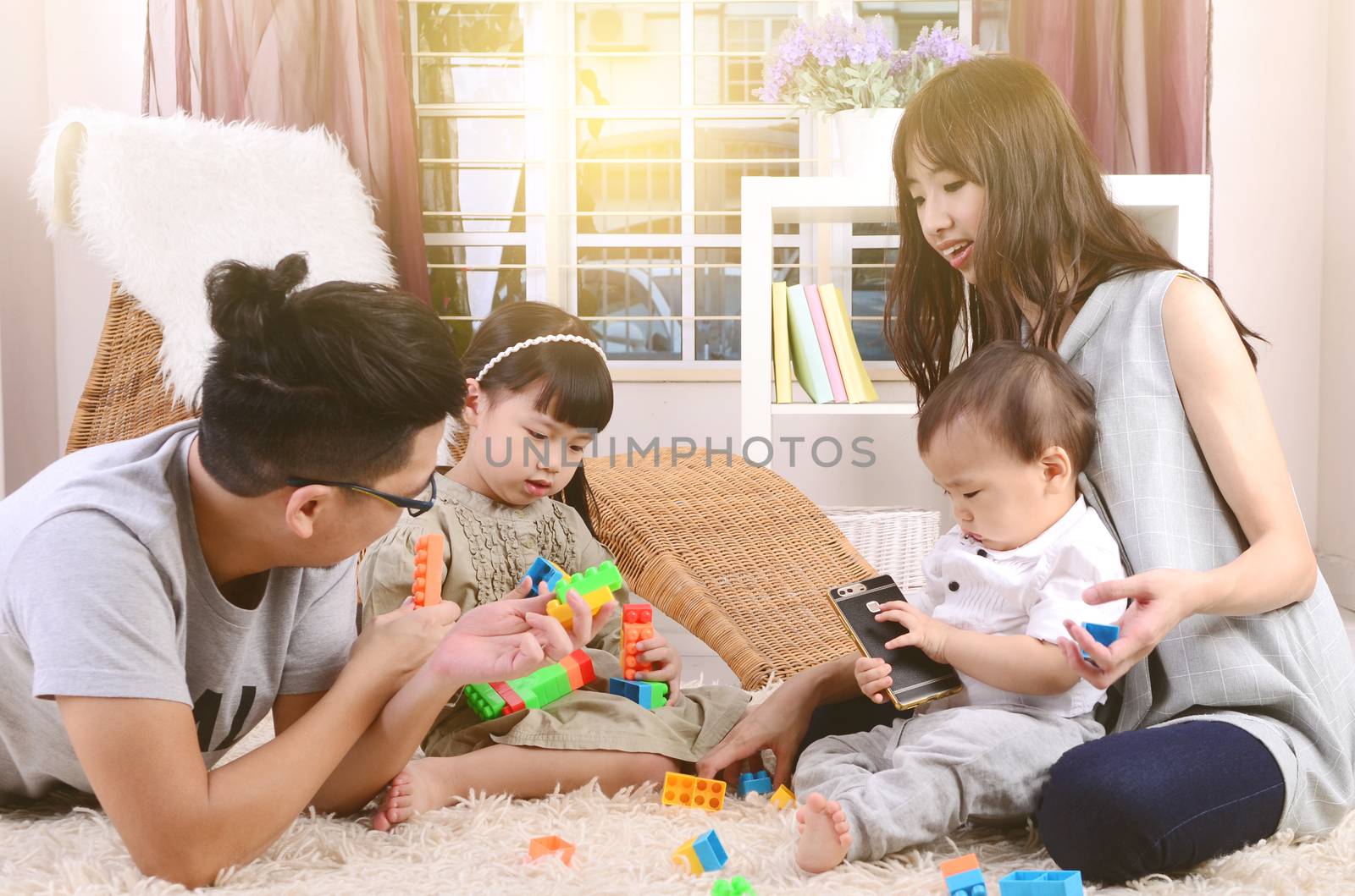 Asian family playing toys at living room