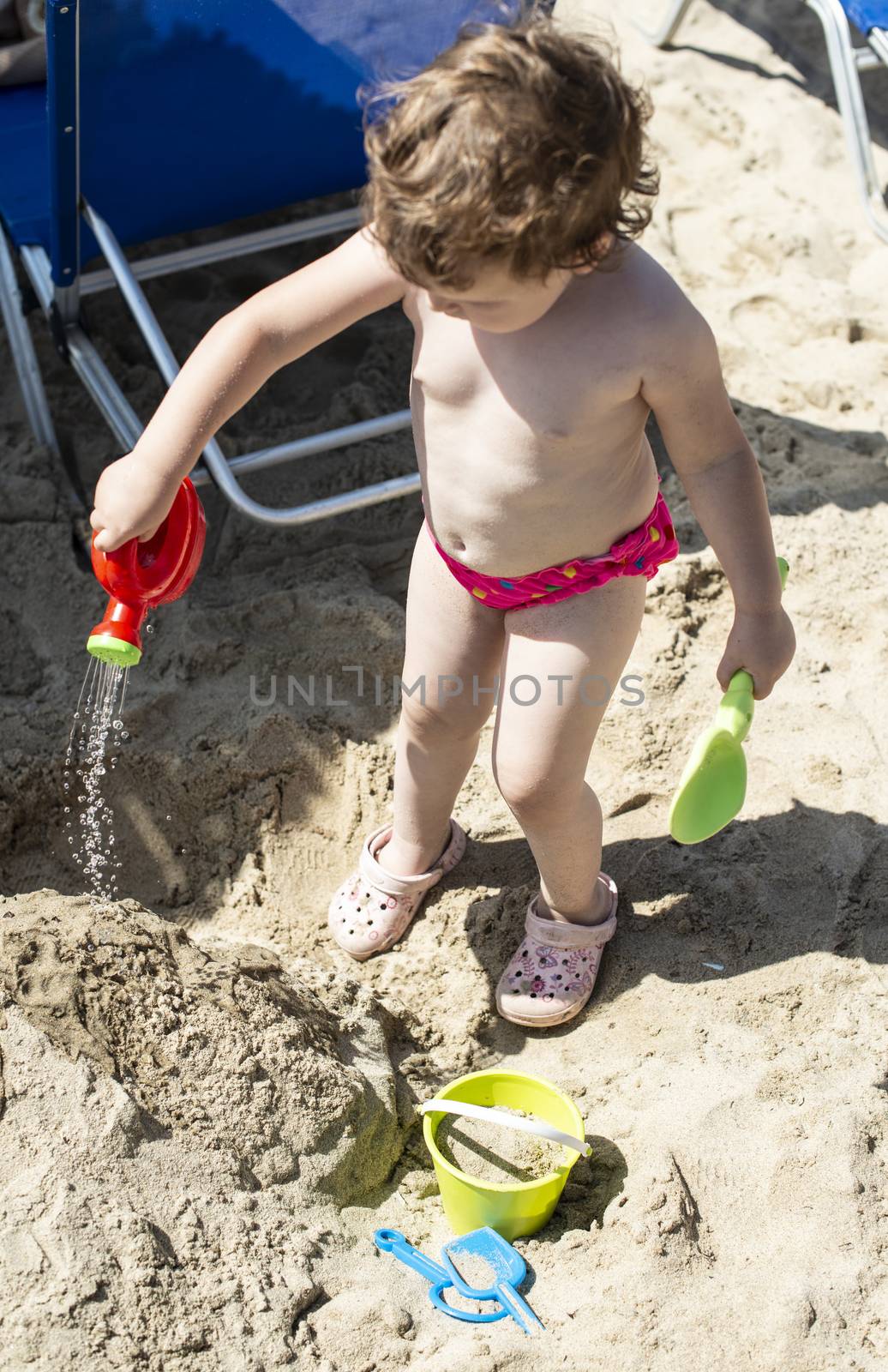 Little girl play on the beach by deyan_georgiev