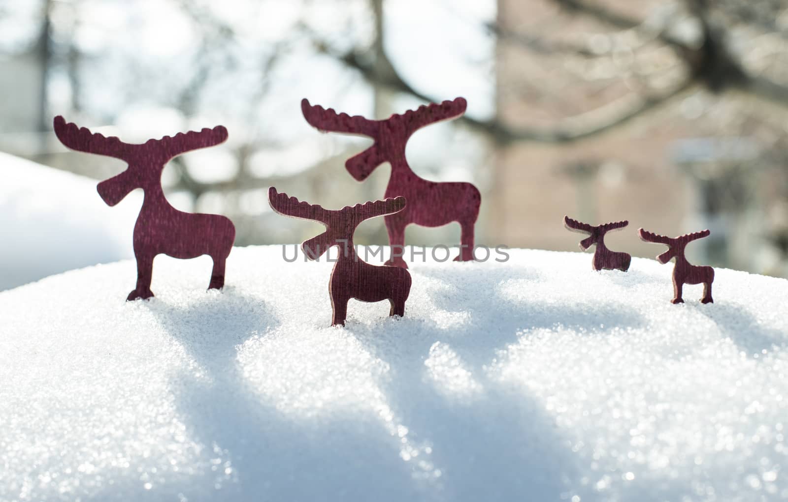 Wooden Christmas deer shape on snow.