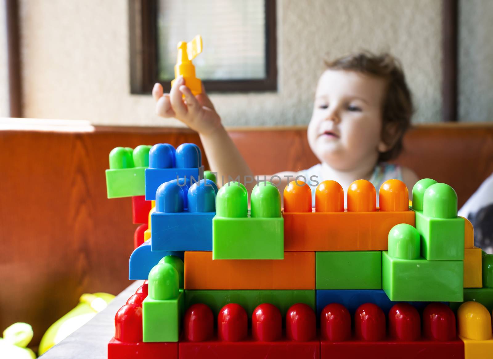 Child playing with cubes. Puts a cube