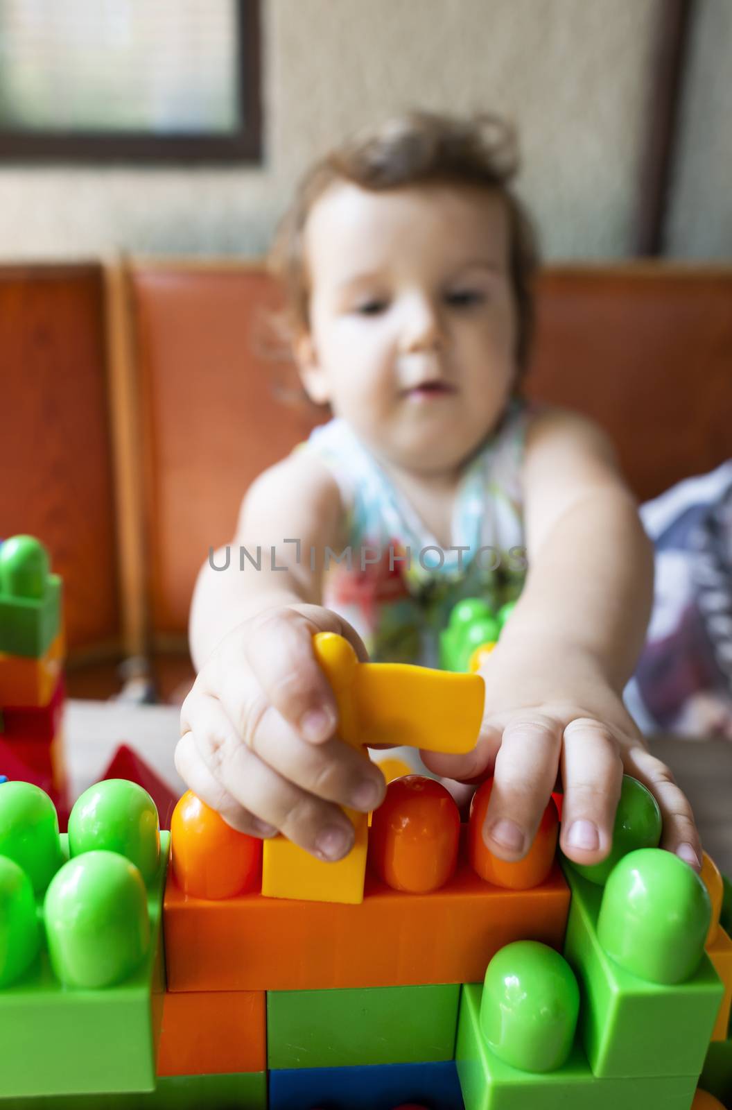 Little girl playing with multicolor blocks