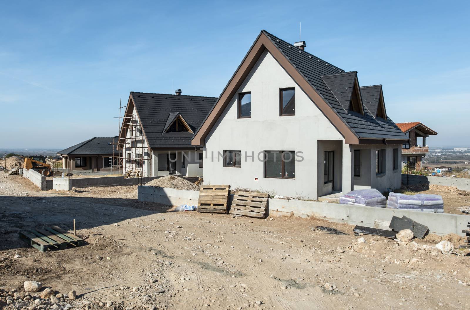 New build houses. Sunny day. Construction site