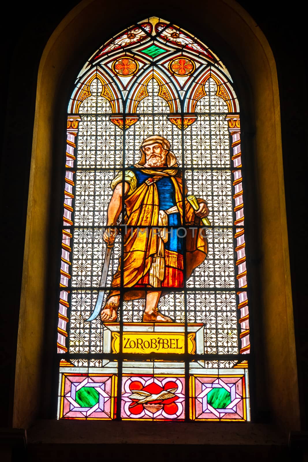 coloured stained glass window colored in a dark background church with Zerubbabel bible character .