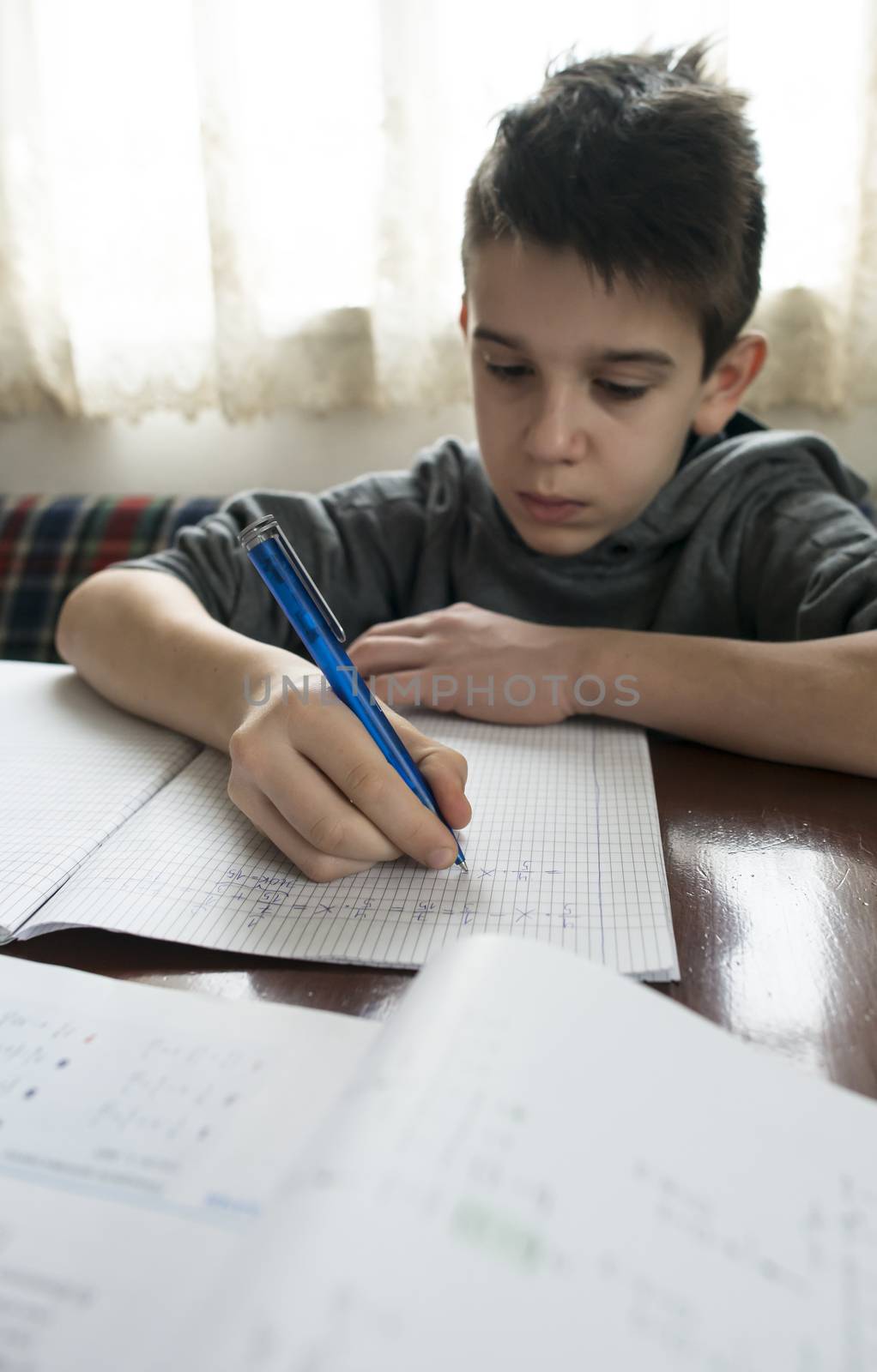 Boy do his homework. Notebook