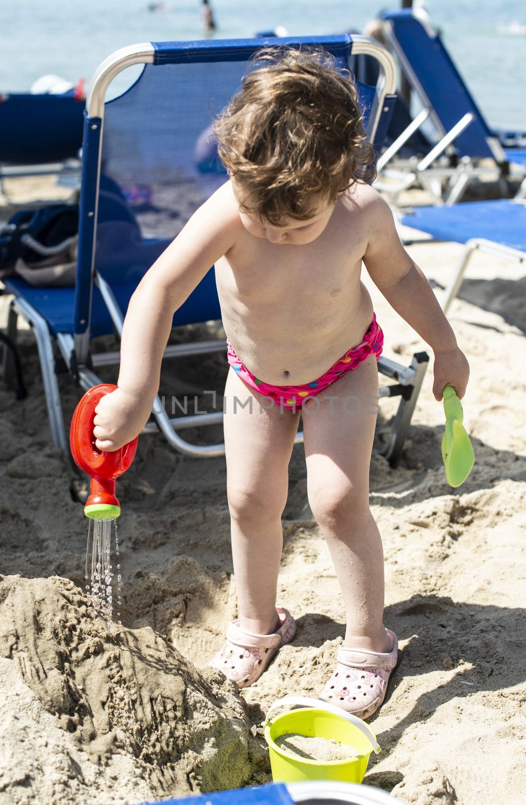 Little girl play on the beach by deyan_georgiev