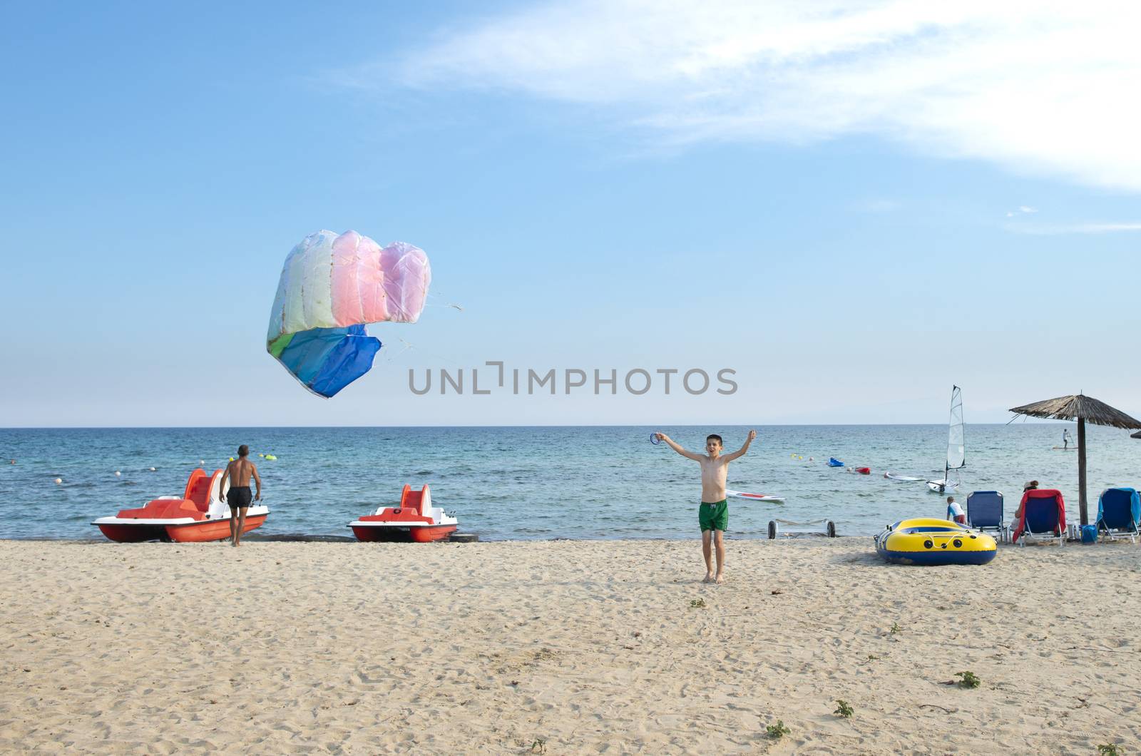 Child play with kite on the beach