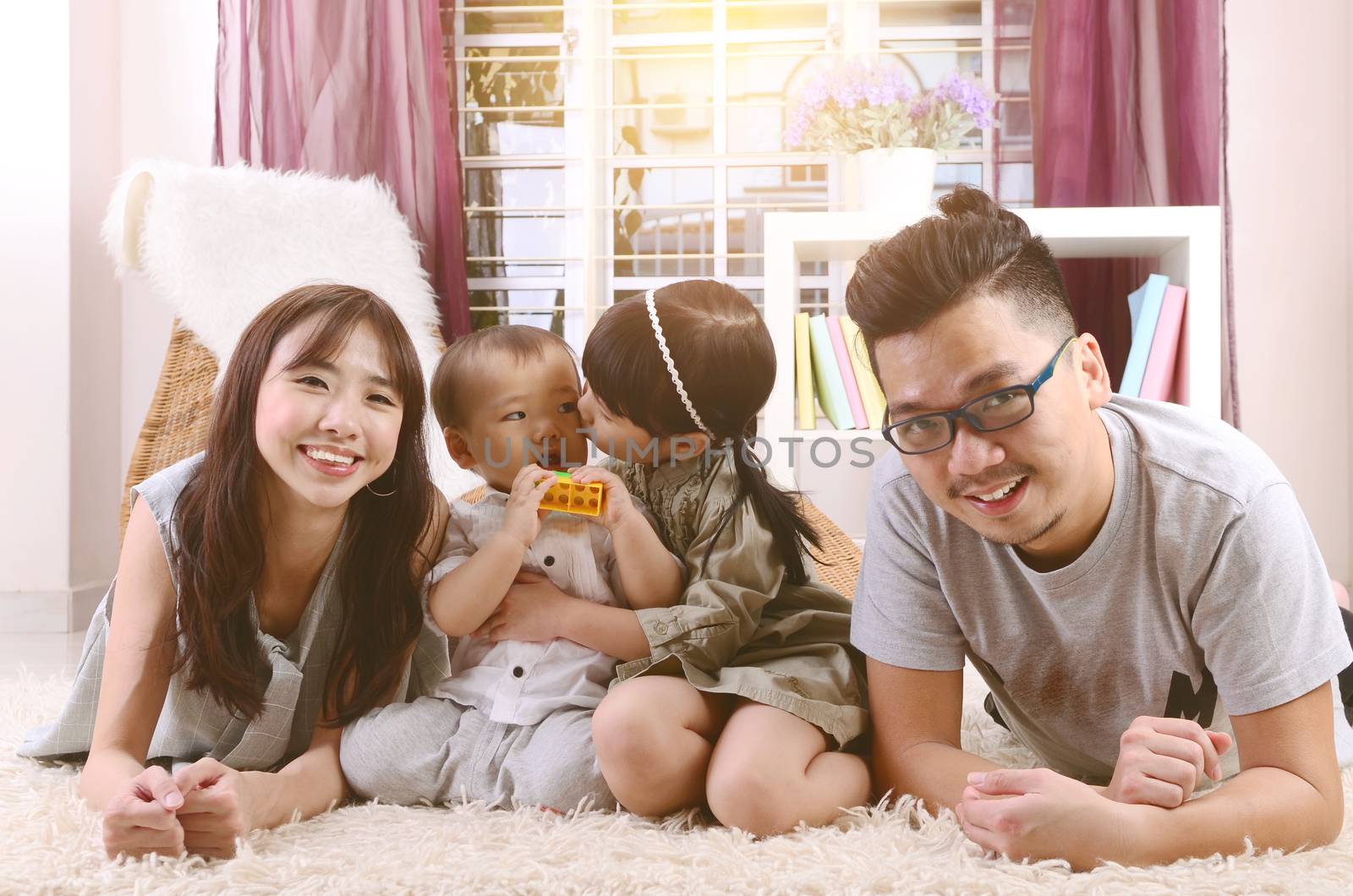 Portrait of asian family lying down at home.
