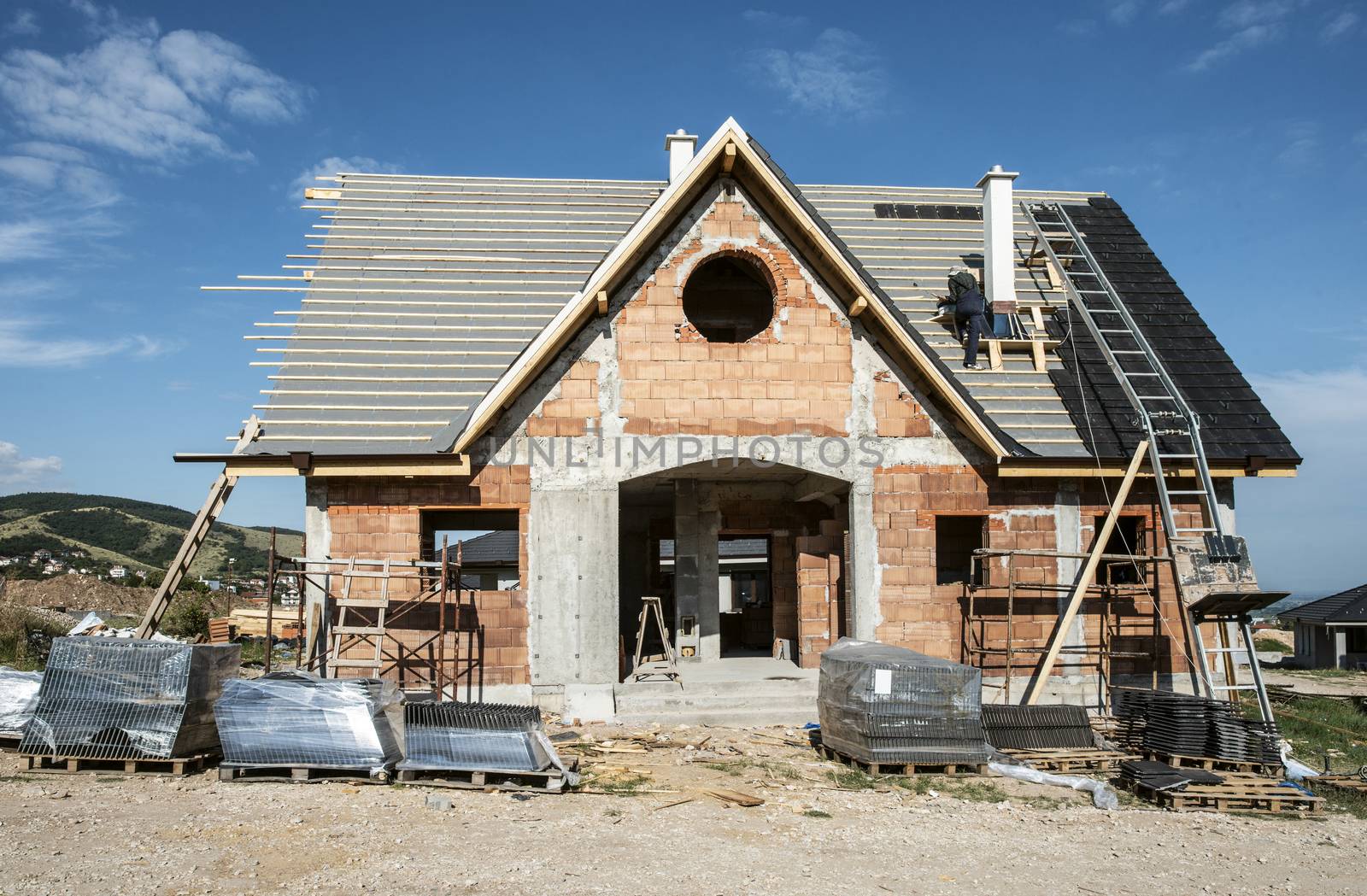 Laying roof tiles on new build house