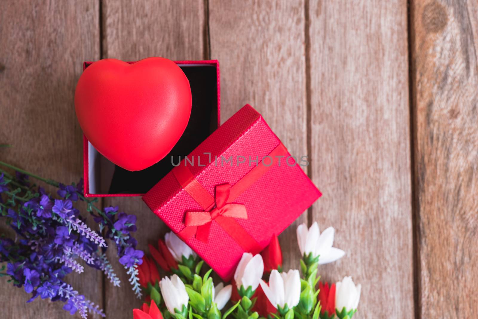 Red heart, flower and gift box on wooden background with copy space, valentine day concept