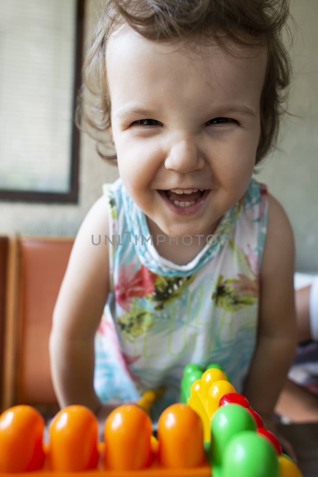 Smiling little girl. Blocks toy