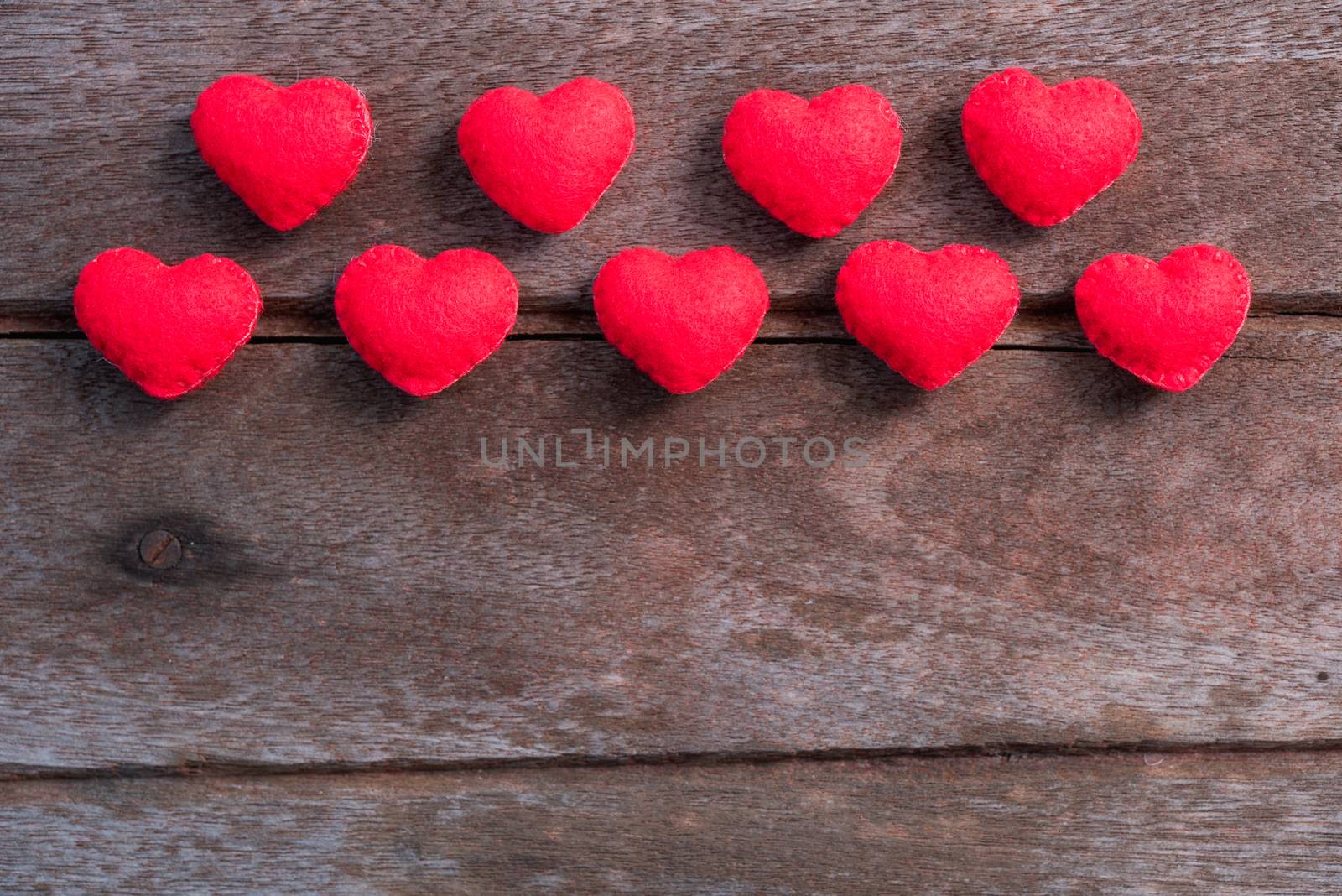 Fabric red heart on wooden background, valentine day concept