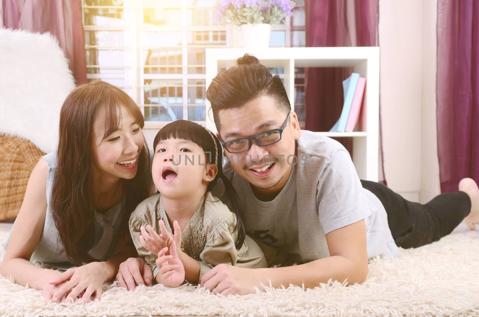 Portrait of asian family lying down at home.