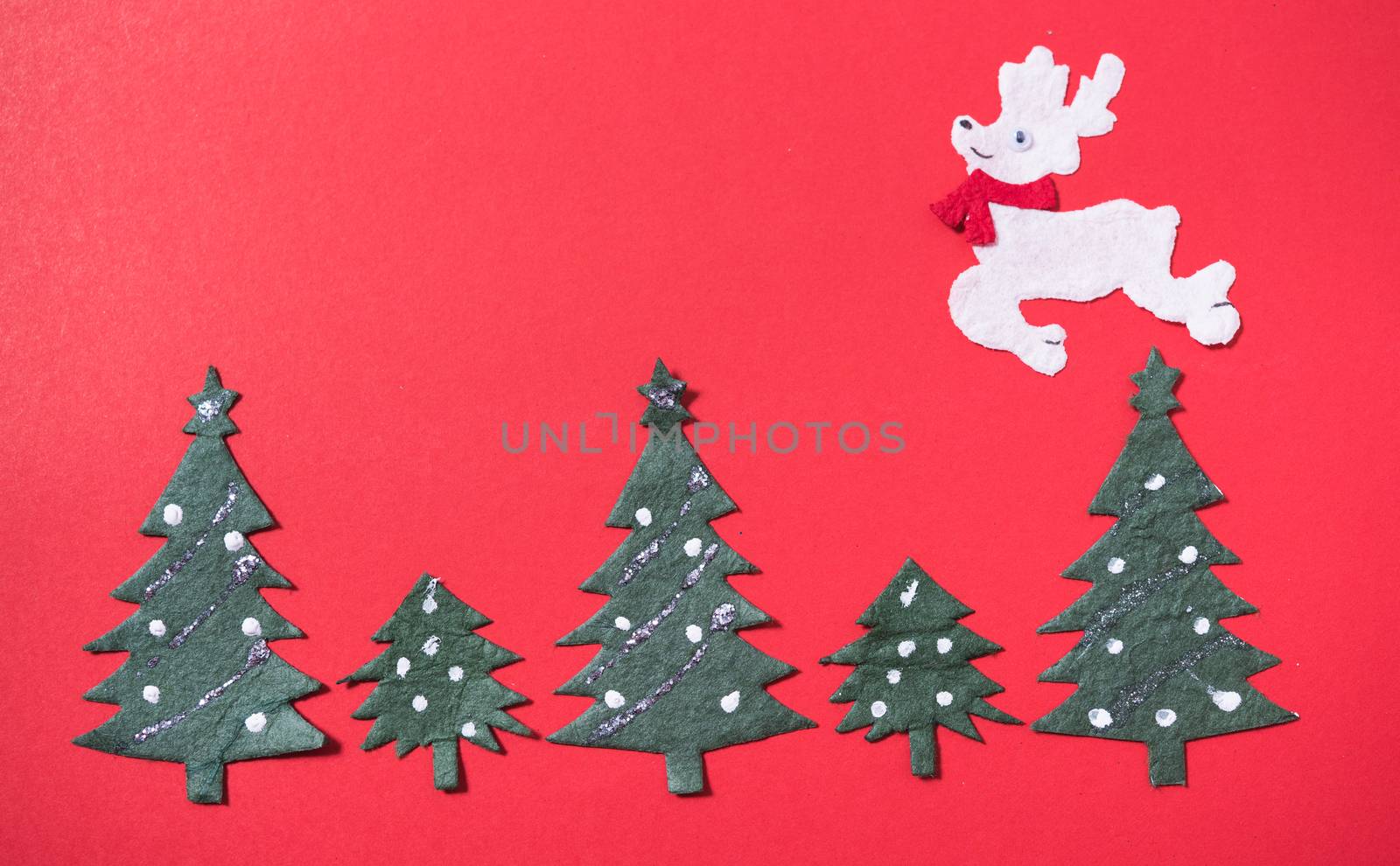 Christmas green tree and deer on red backgroun, have copy space for use