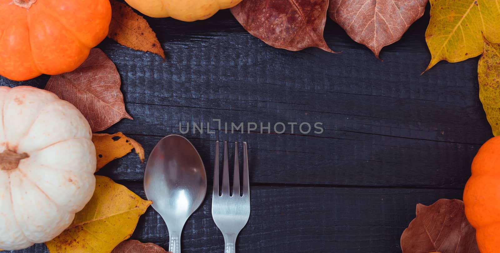 Fall Thanksgiving and Halloween pumpkins and dry leaves by Sorapop