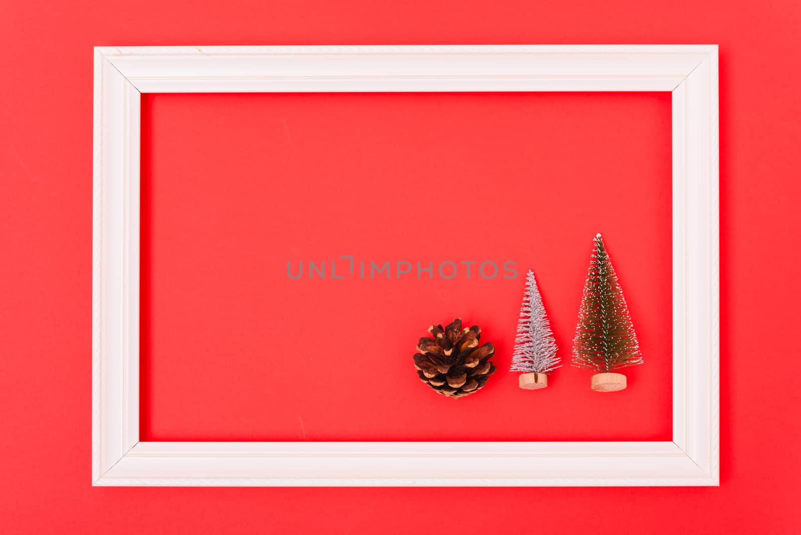 New Year, Christmas Xmas holiday composition, Top view green fir tree branch in frame on red background with copy space