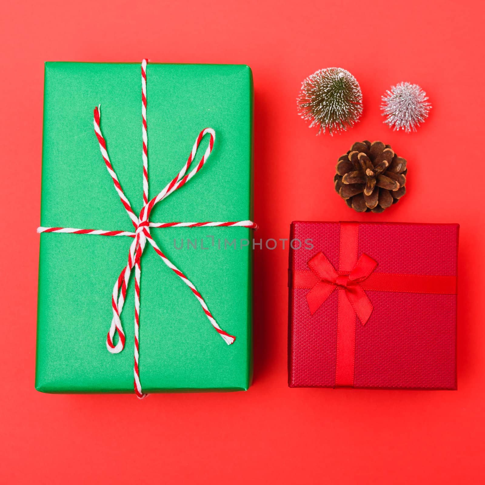 New Year, Christmas Xmas holiday composition, Top view green and red gift box and green fir tree branch on red background