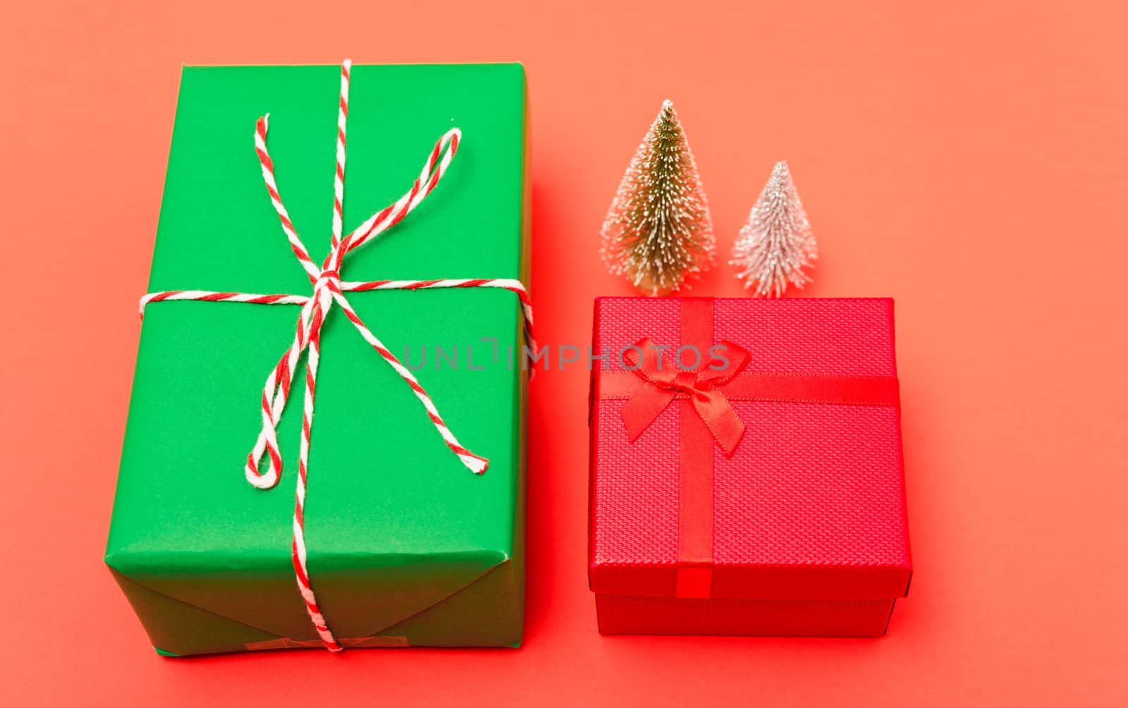 New Year, Christmas Xmas holiday composition, Top view green and red gift box and green fir tree branch on red background