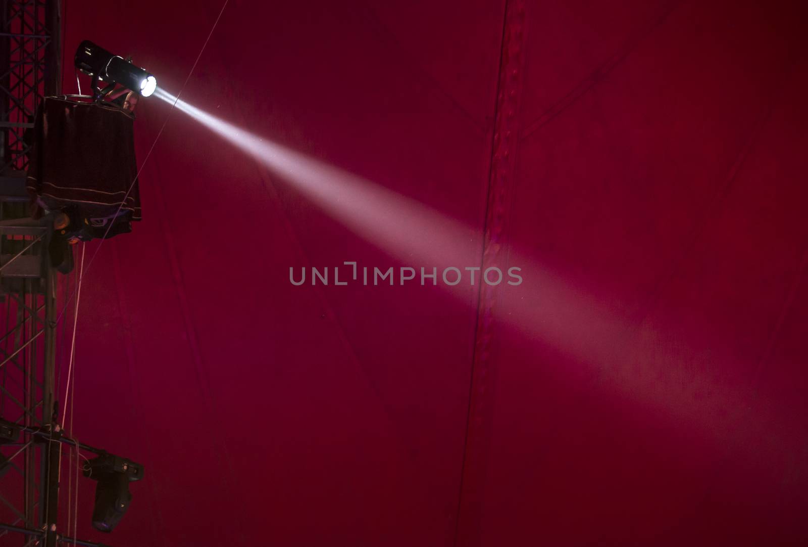  Limelight and red background on the scene. Flood lighting in the circus.