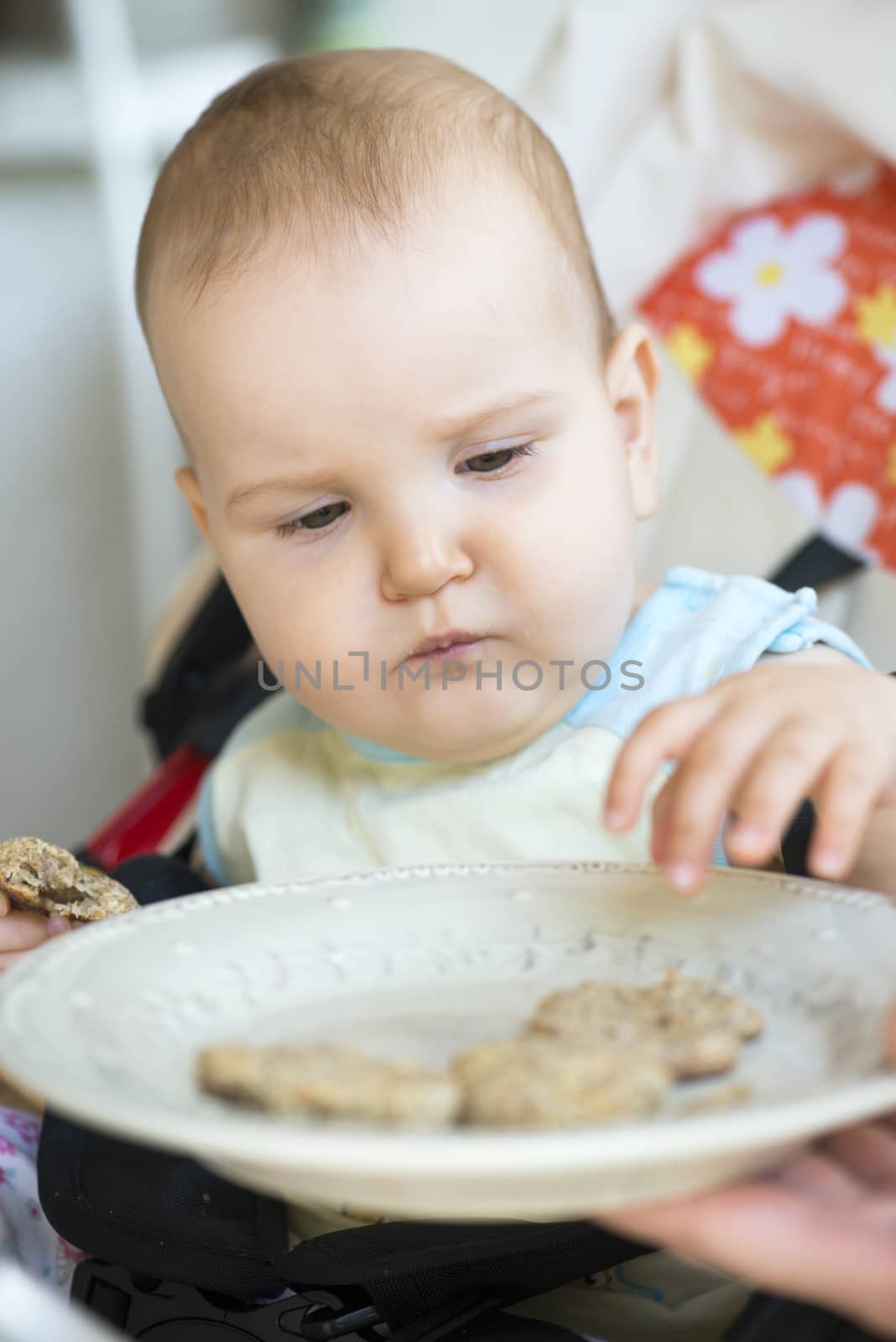 Baby eats alone. by deyan_georgiev