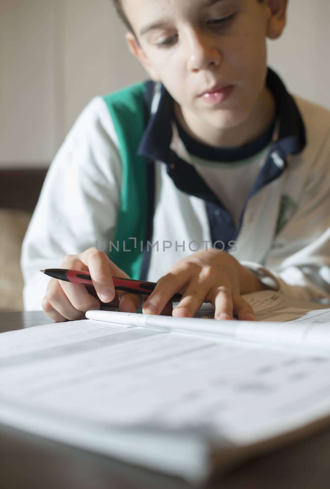 Child do his homework. Hand hold pen. Boy learning by deyan_georgiev