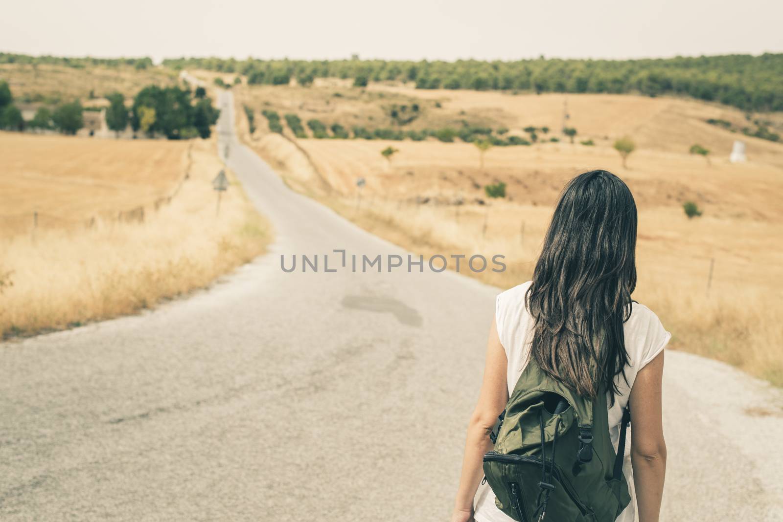 Woman walking on the road by deyan_georgiev
