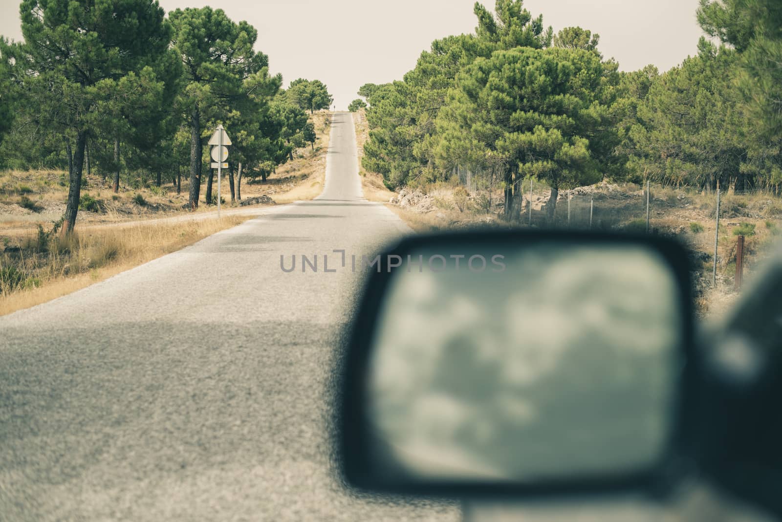 Tourist car on the road. Close up mirror