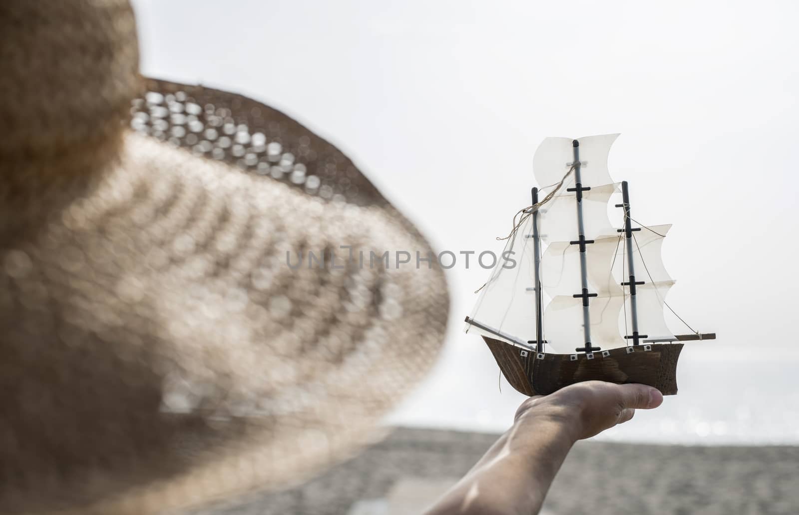 Woman hold boat model on the beach by deyan_georgiev