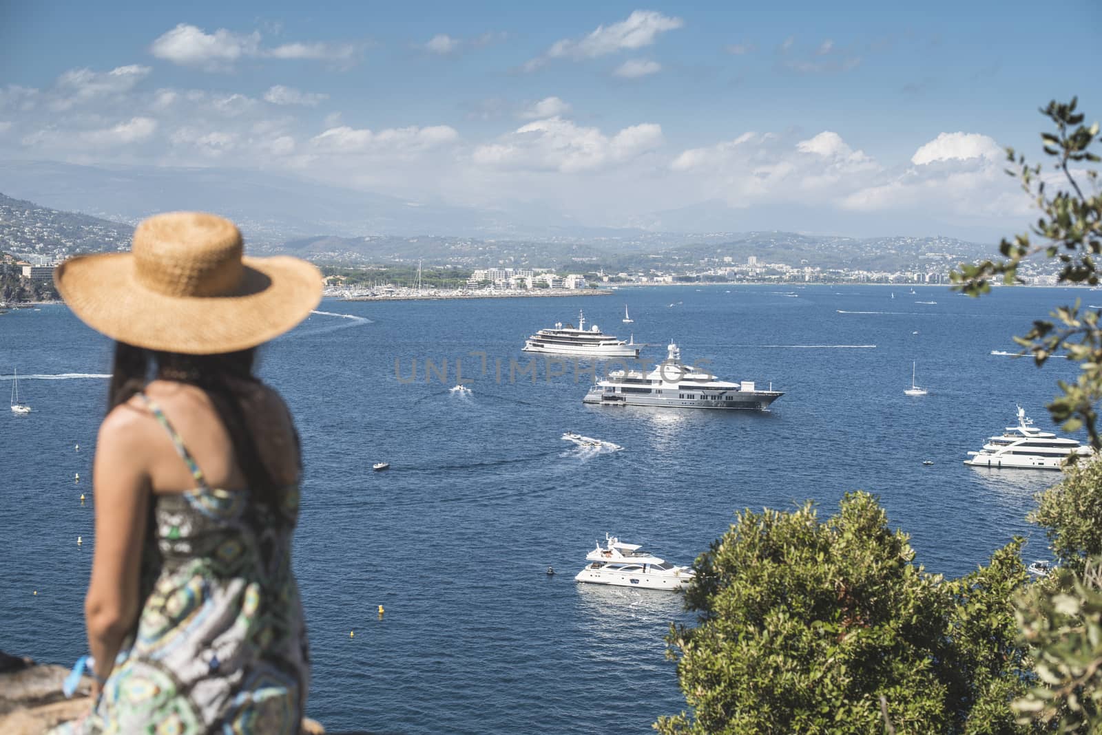 Woman with summer hat watching yachts by deyan_georgiev