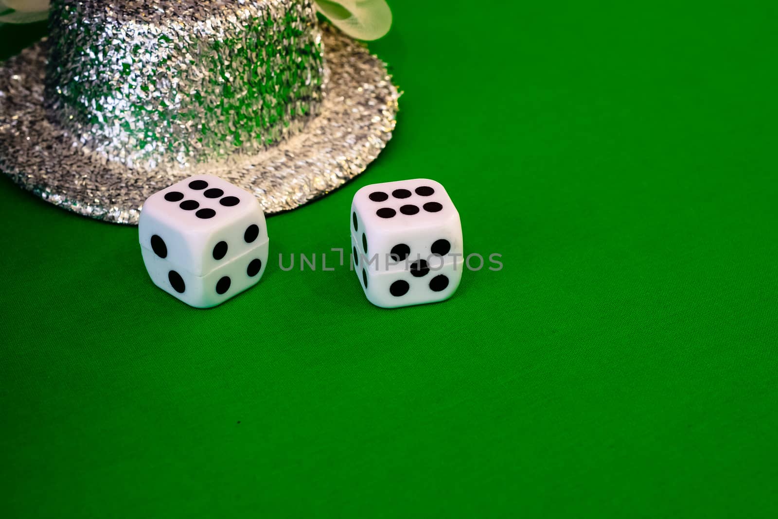 white dice on green cloth or tablecloth