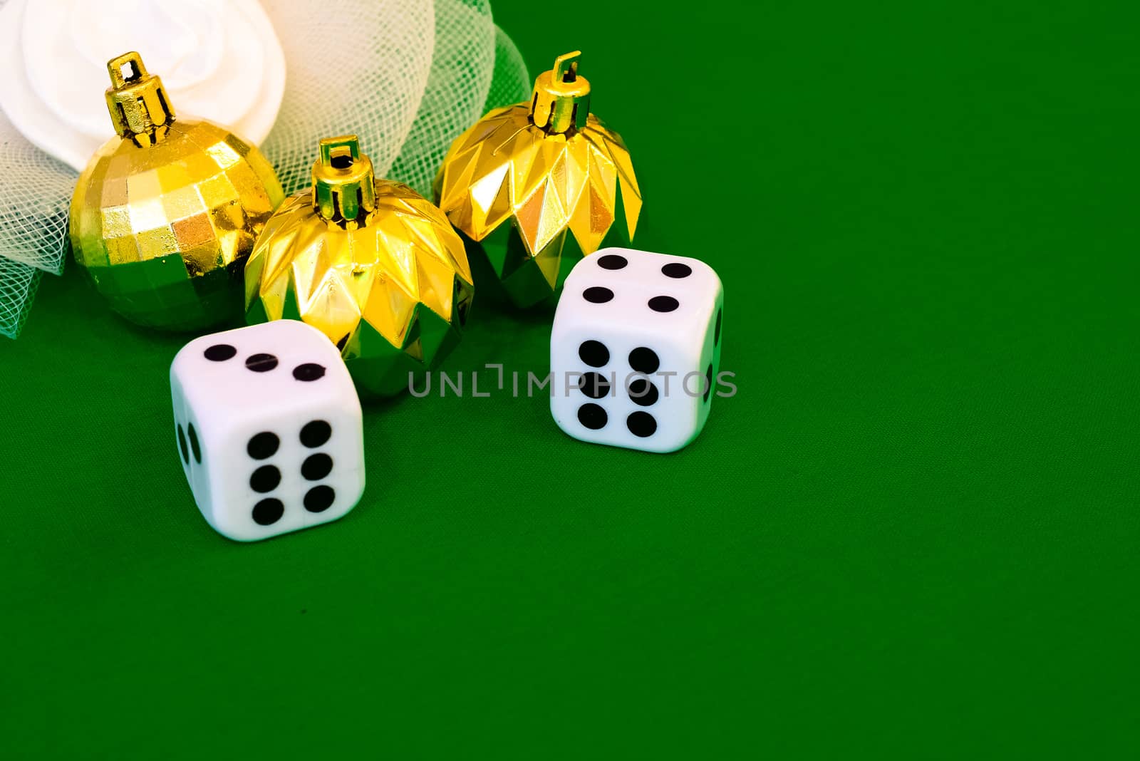 white dice on green cloth or tablecloth