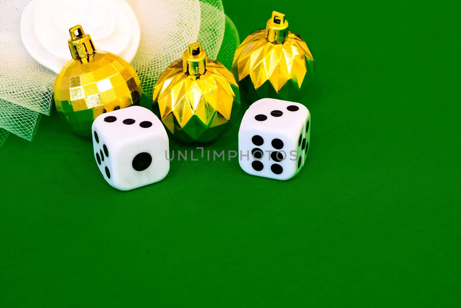 white dice on green cloth or tablecloth