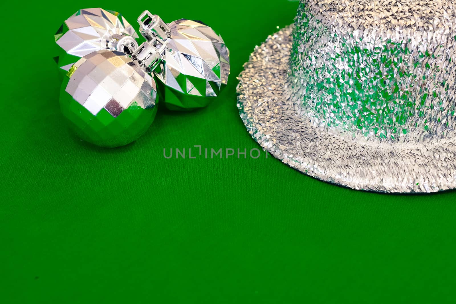 Christmas decoration silver or gold on green tablecloth or cloth