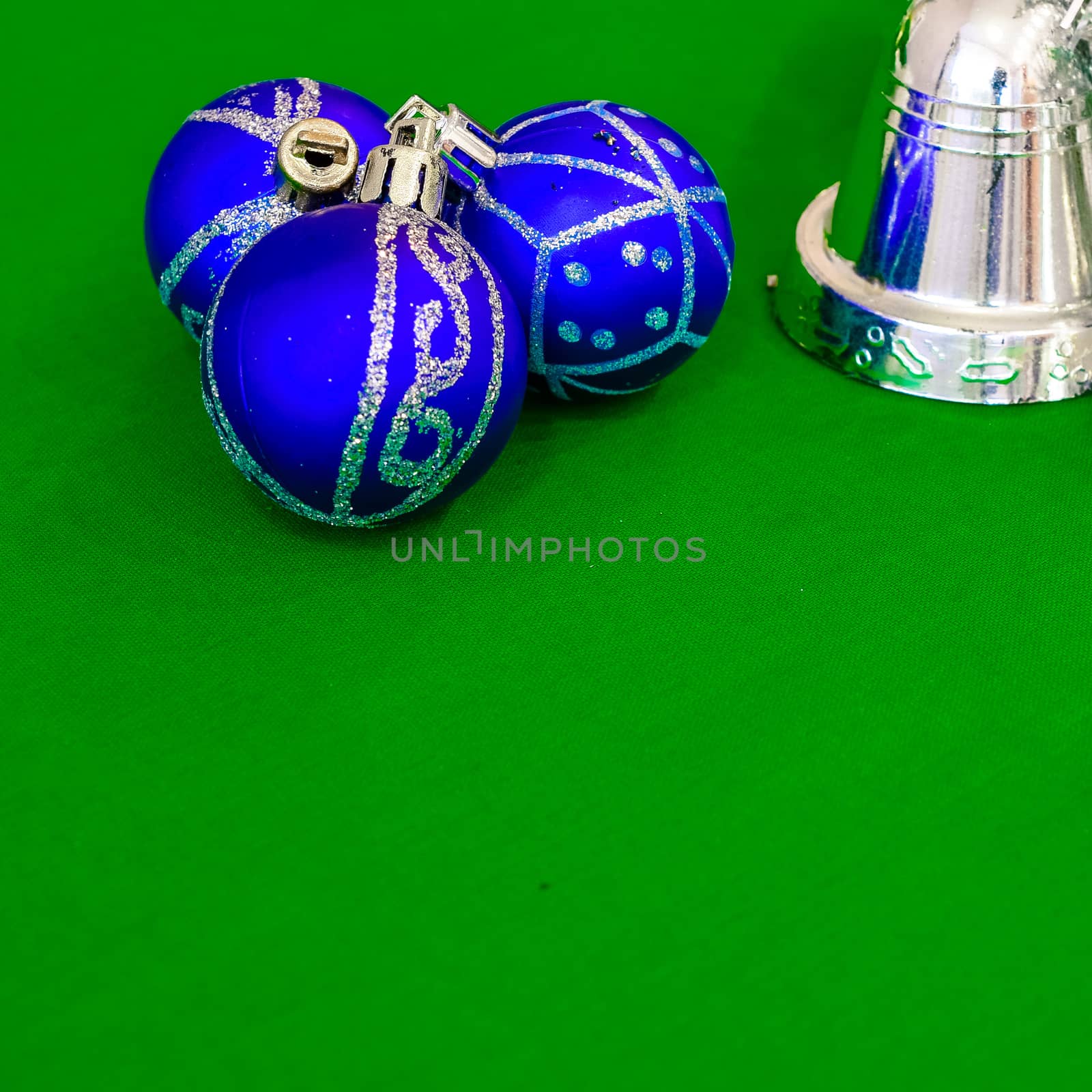 Christmas decoration silver or gold on green tablecloth or cloth