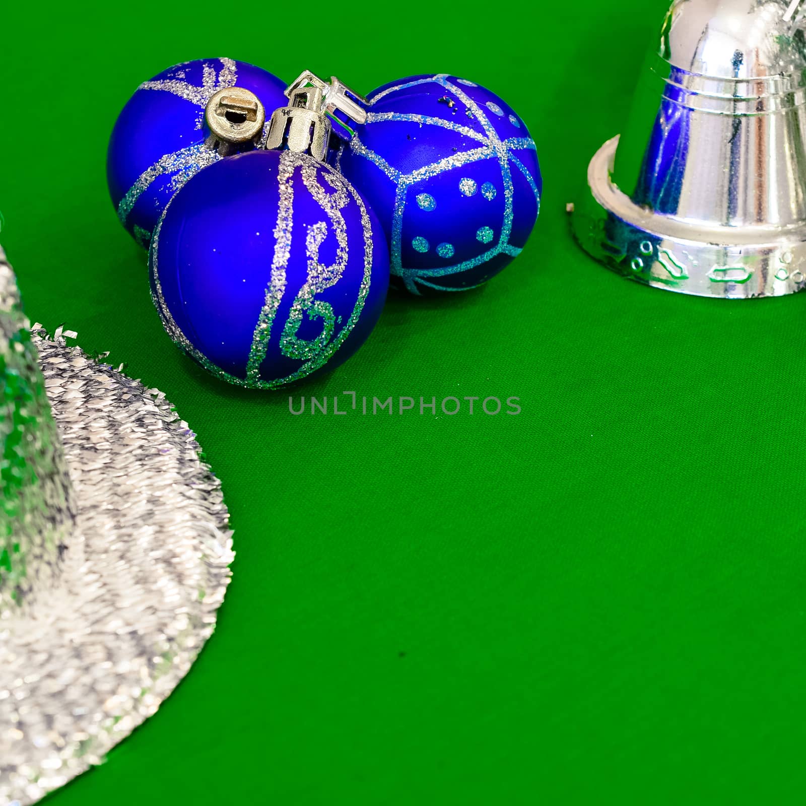 Christmas decoration silver or gold on green tablecloth or cloth by alexandr_sorokin