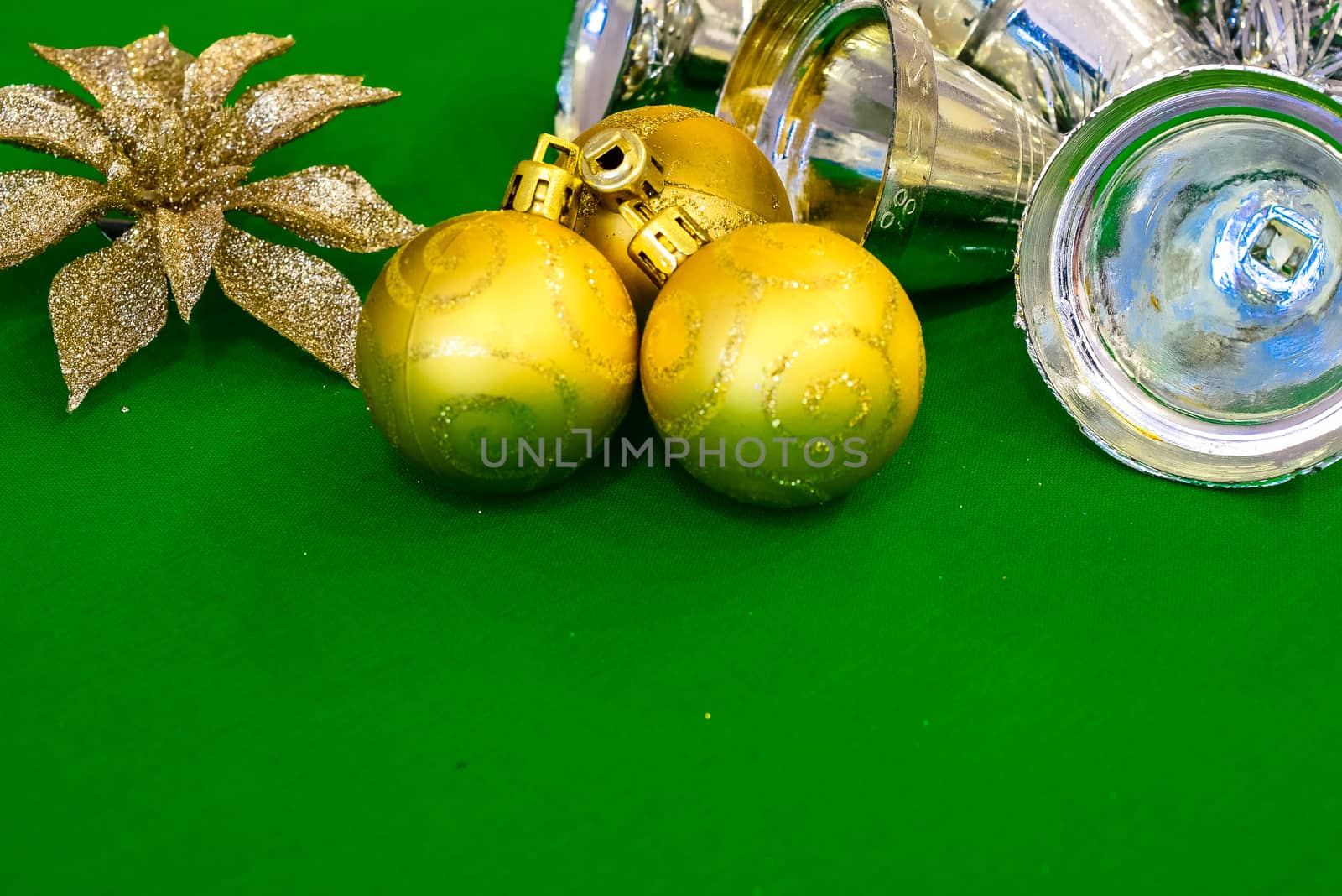 Christmas decoration silver or gold on green tablecloth or cloth