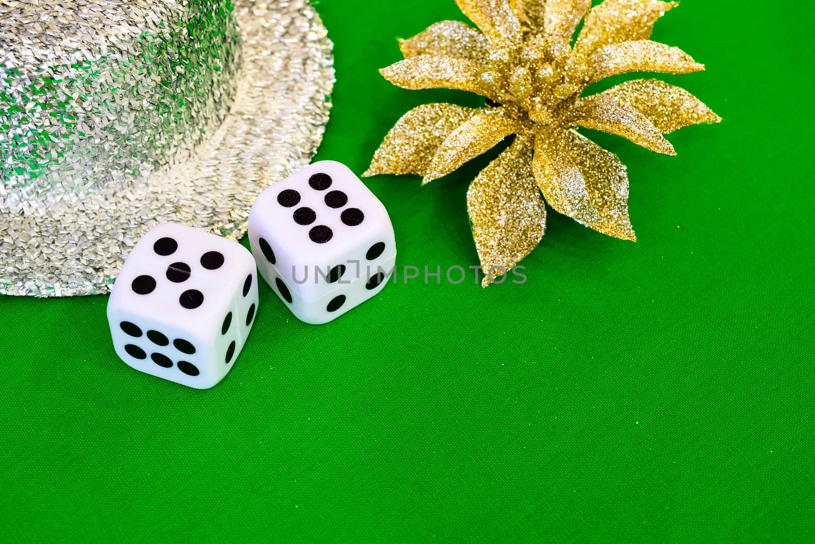 white dice on green cloth or tablecloth