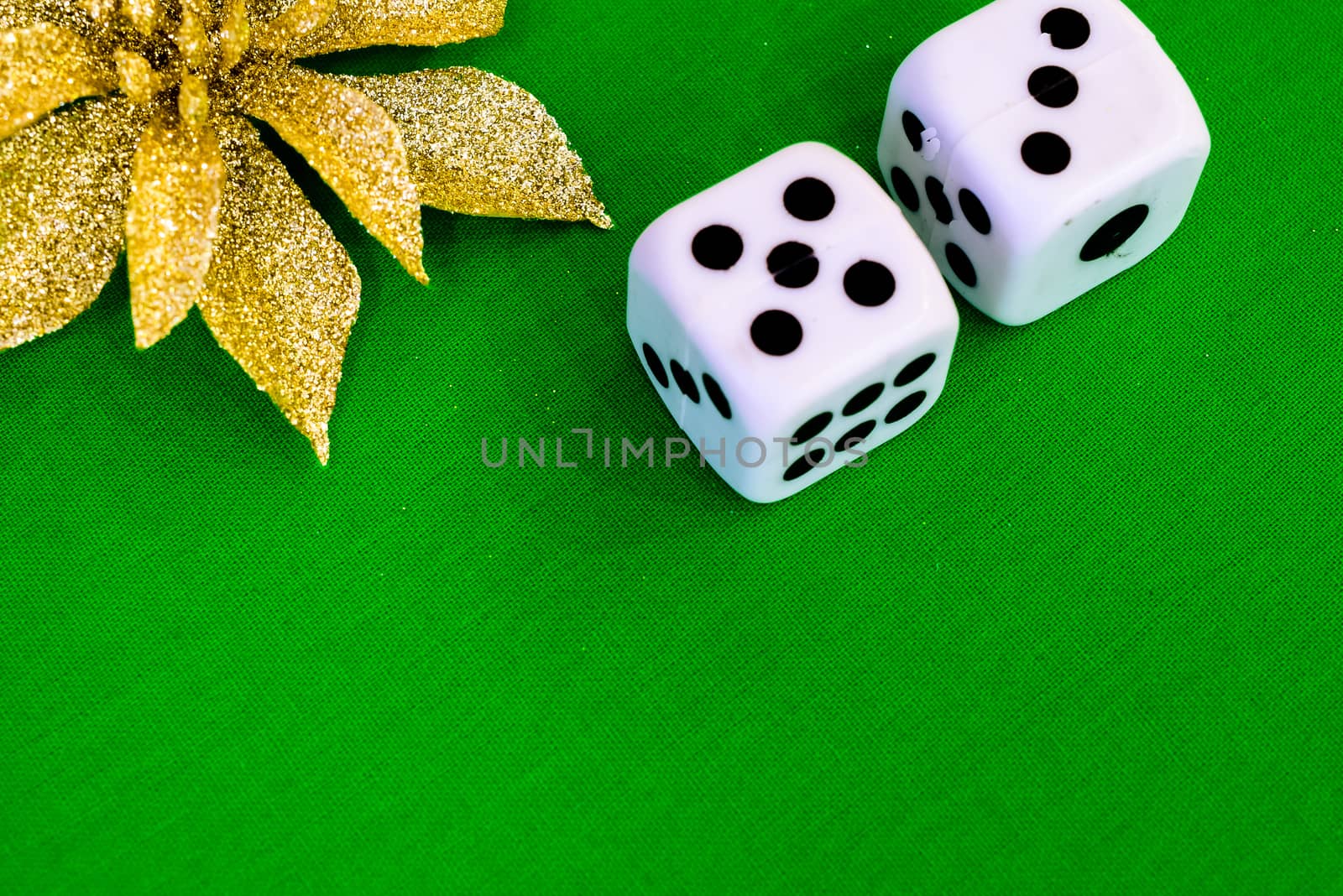 white dice on green cloth or tablecloth