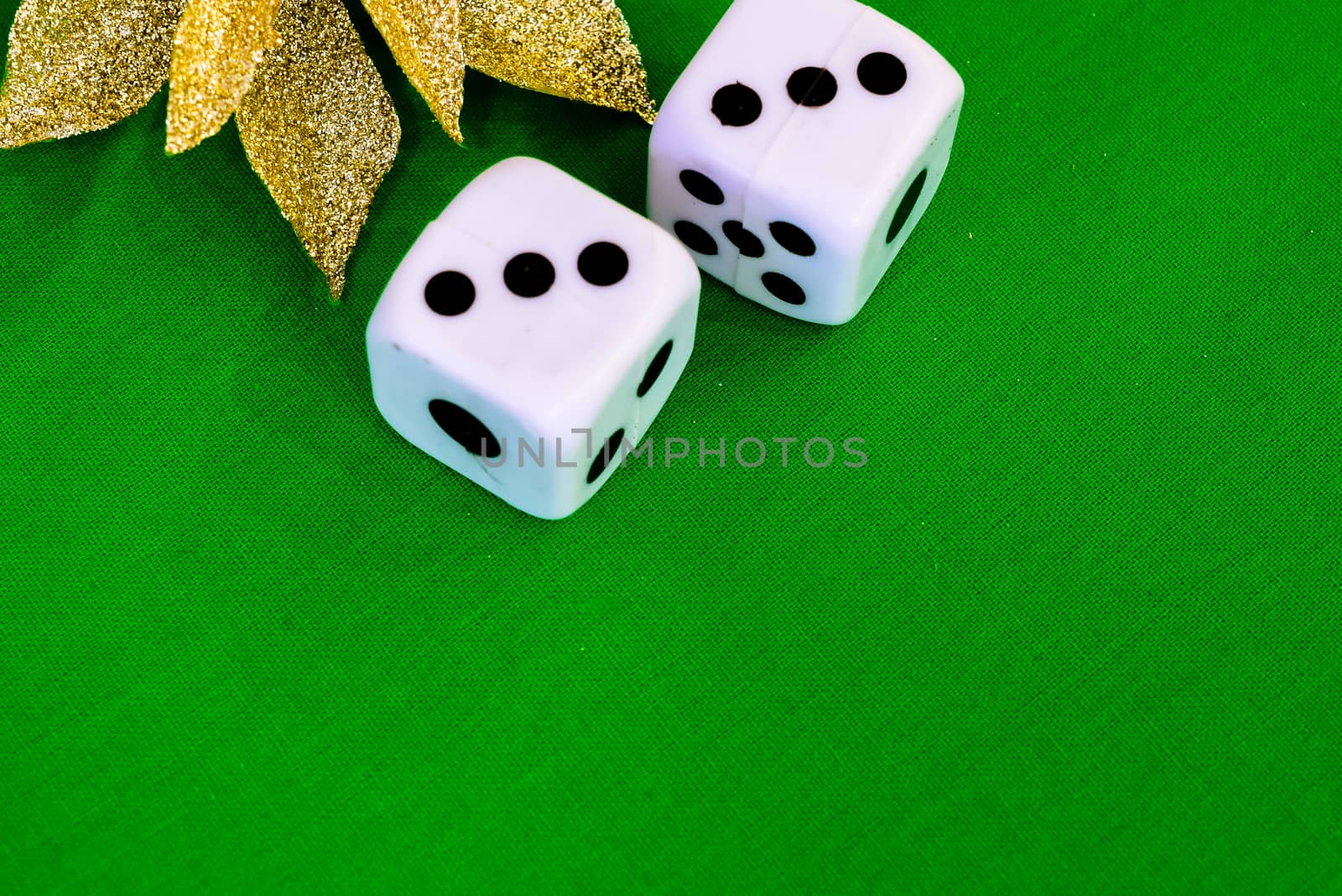 white dice on green cloth or tablecloth