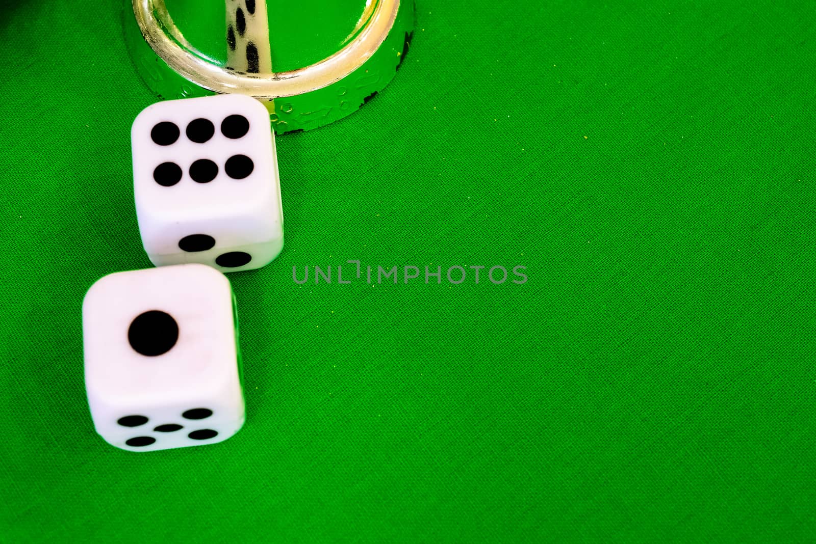 white dice on green cloth or tablecloth