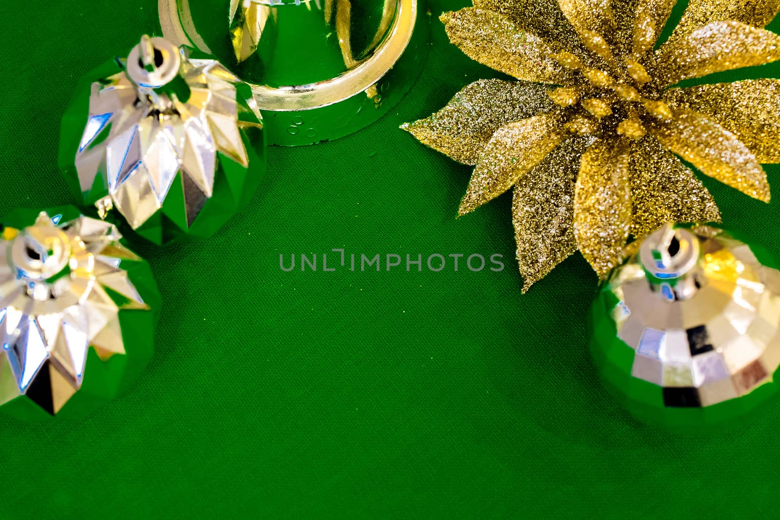 Christmas decoration silver or gold on green tablecloth or cloth