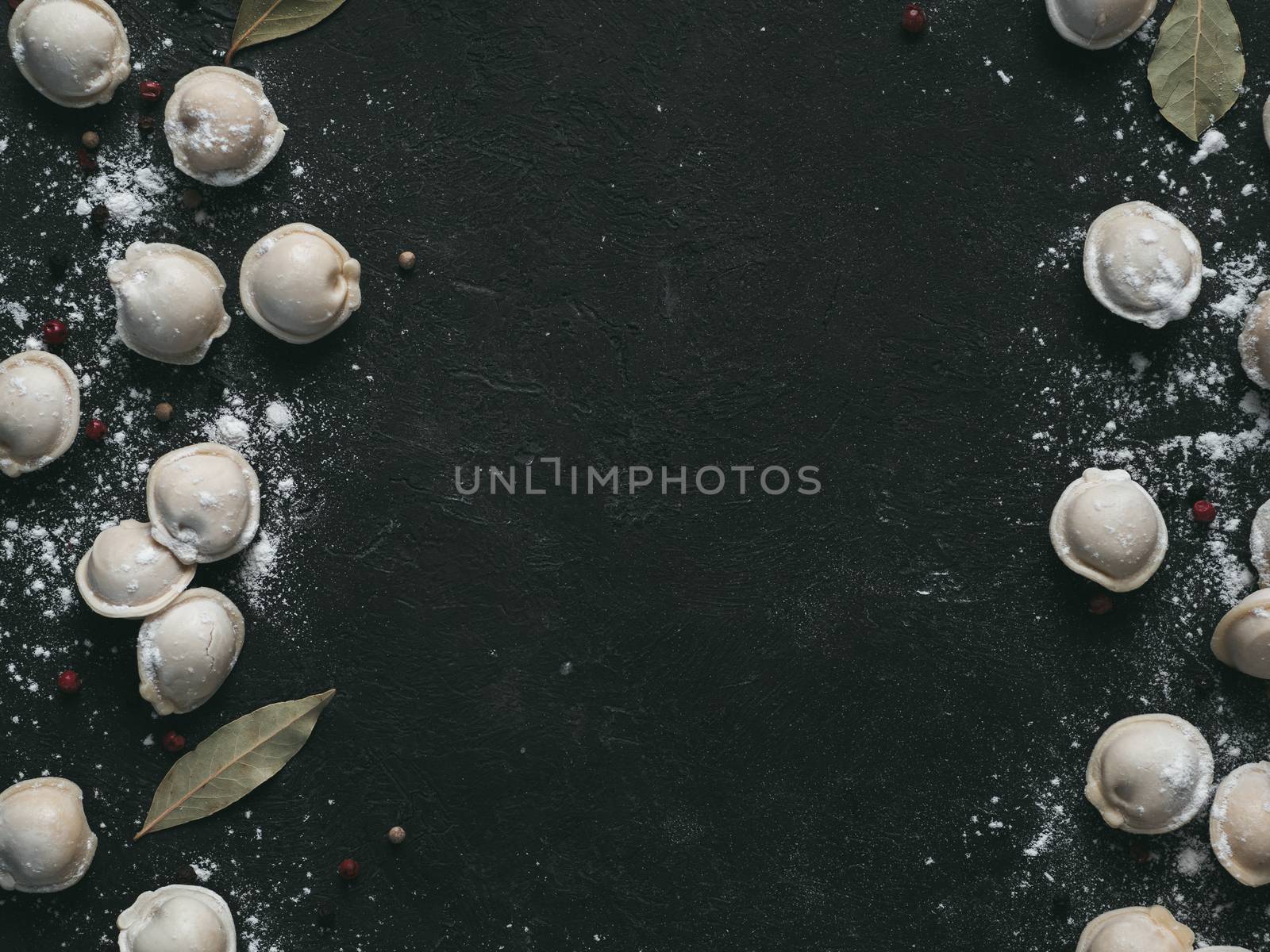 Beautiful scattered raw pelmeni on marble background by fascinadora