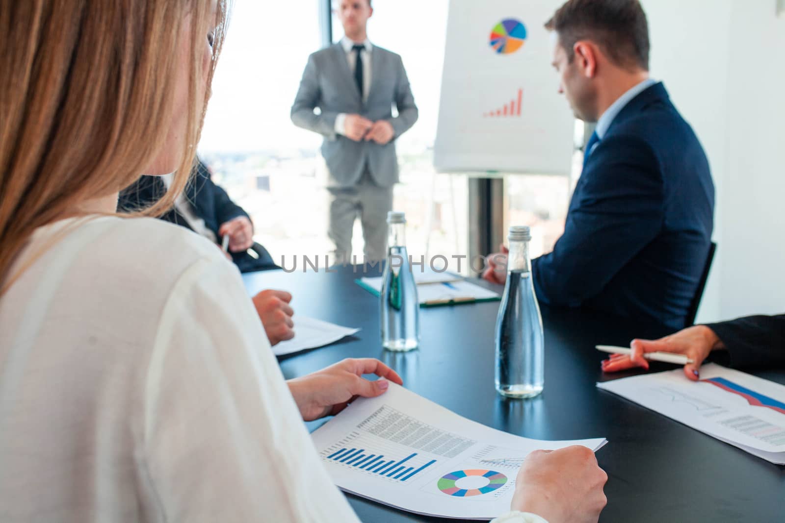 Business people in meeting presentation working with financial data statistics