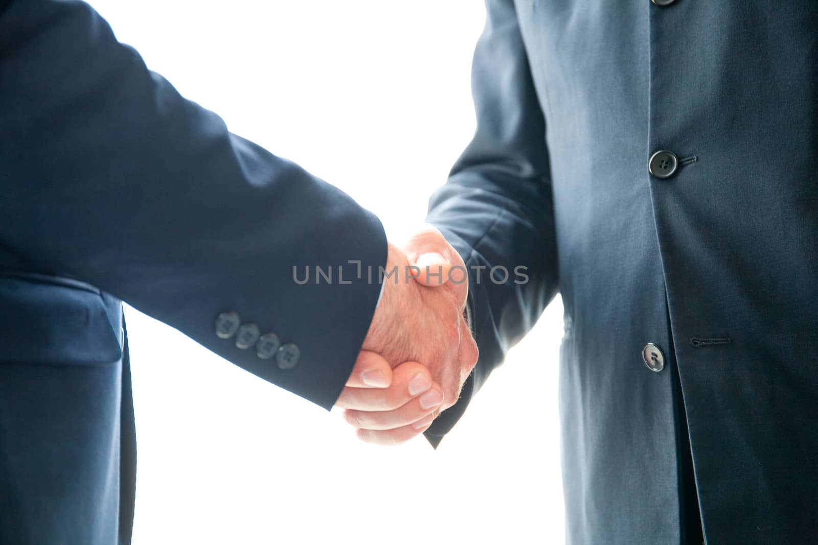 Handshake of business people in fotmal wear, white background